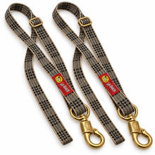 Load image into Gallery viewer, Studio presentation of two Baker plaid cross ties with brass hardware
